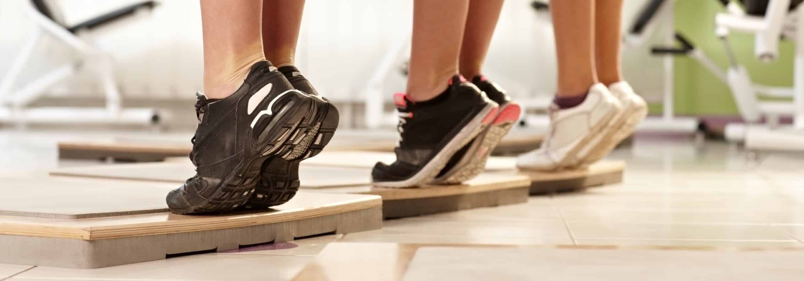 Läuferin beim Training mit Achillessehnenschmerzen durch Achillessehnenentzündung, Übungen für die Achillessehne
